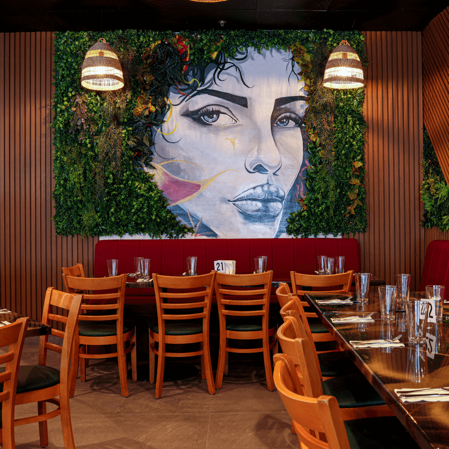 Restaurant interior with wall art mural and greenery decor