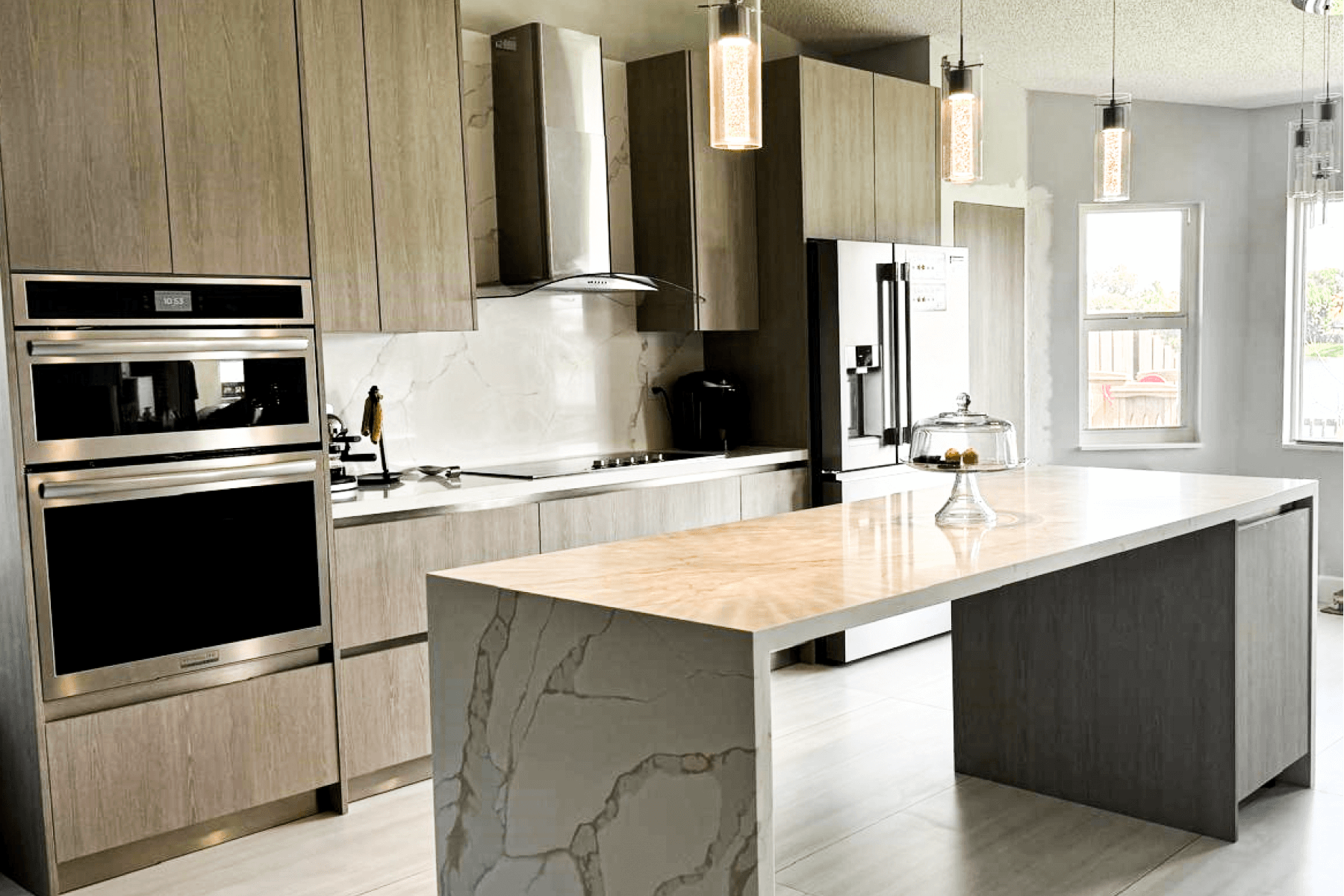 Modern kitchen with wood cabinets, marble backsplash, stainless steel appliances, and a quartz island countertop