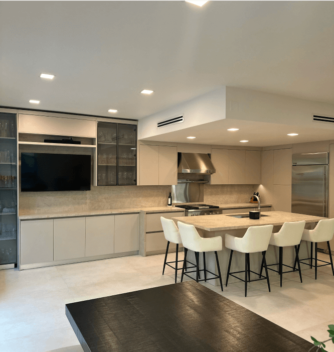 Modern kitchen with beige cabinets, marble island, and dining area